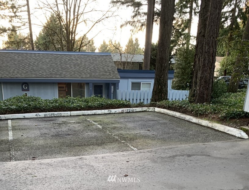 4308 Northeast Sunset Boulevard, Unit F3 Renton, WA 98059 - Photo 21 of 26 a front view of a house with a yard and garage