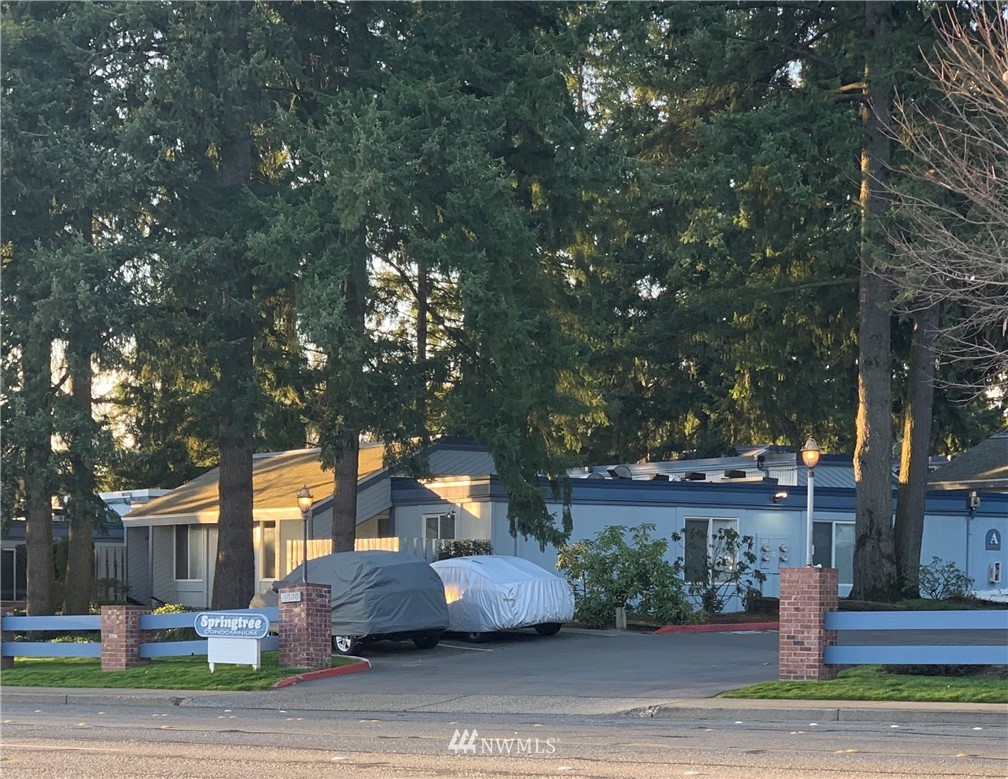 4308 Northeast Sunset Boulevard, Unit F3 Renton, WA 98059 - Photo 25 of 26 a front view of a house with a yard and tree s