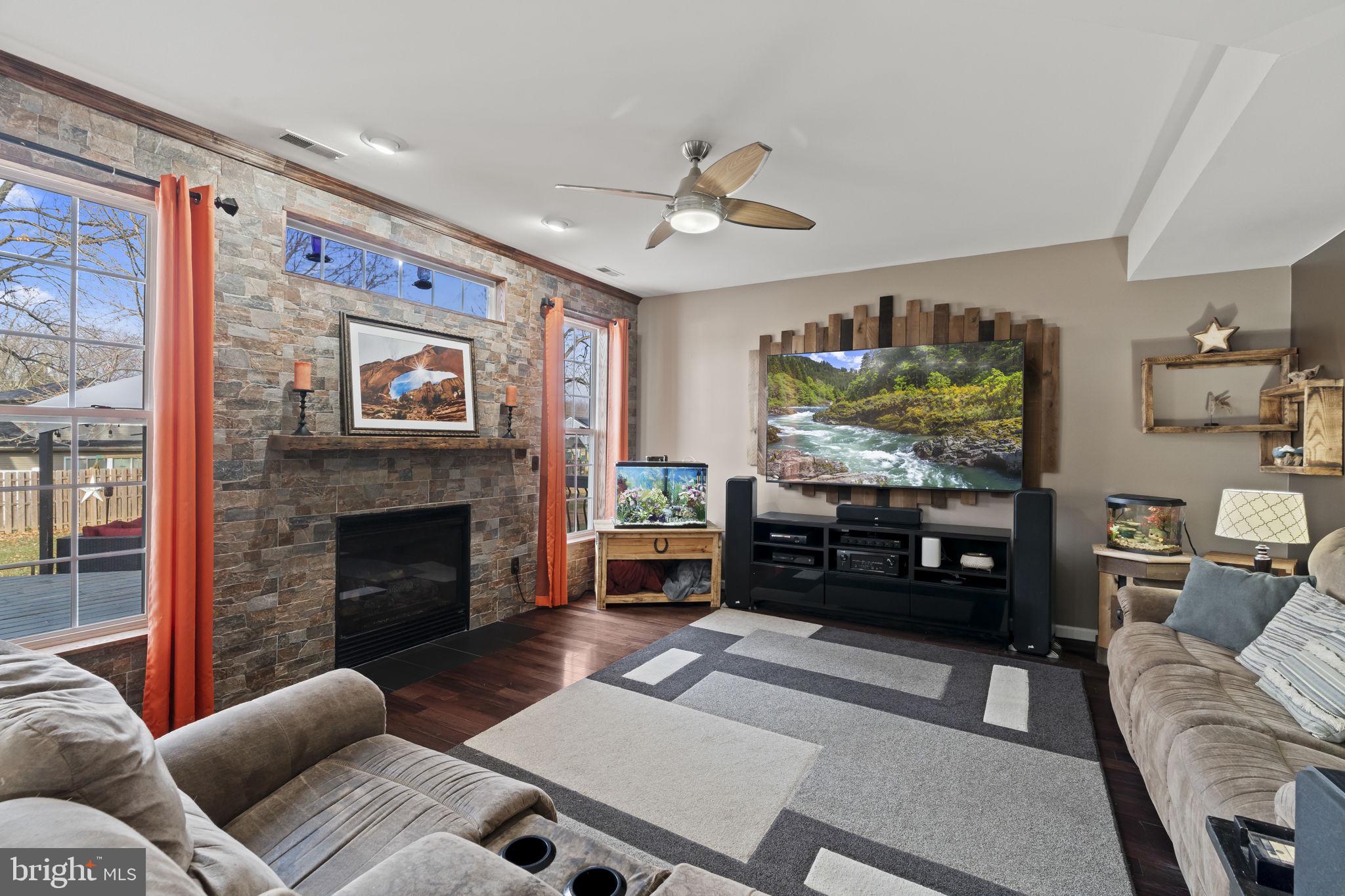 5 Panama Court Carneys Point, NJ 08069 - Photo 11 of 36 a living room with furniture a fireplace and a flat screen tv