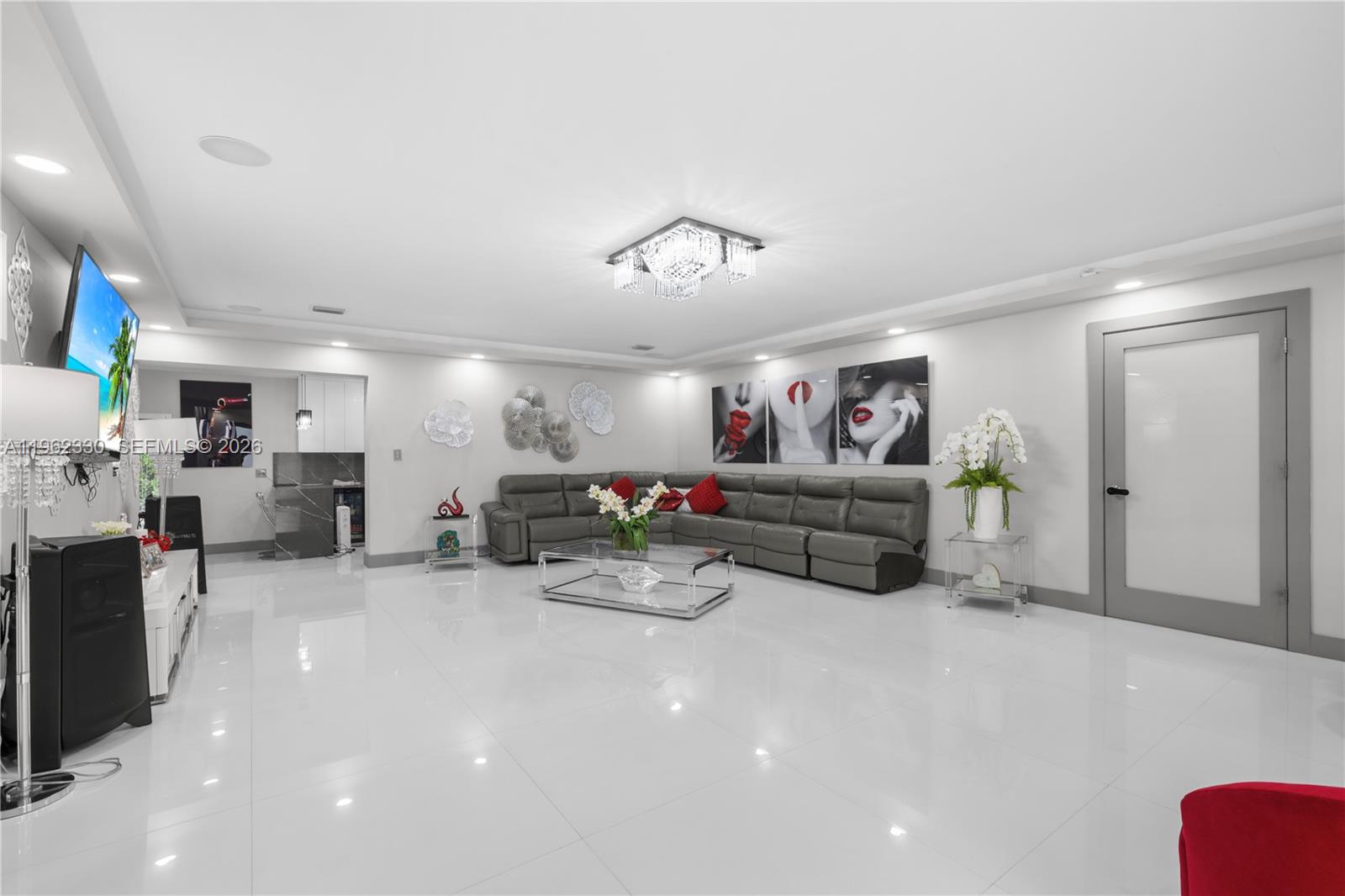 33300 Southwest 212th Avenue Homestead, FL 33034 - Photo 12 of 60 a living room with furniture and a flat screen tv