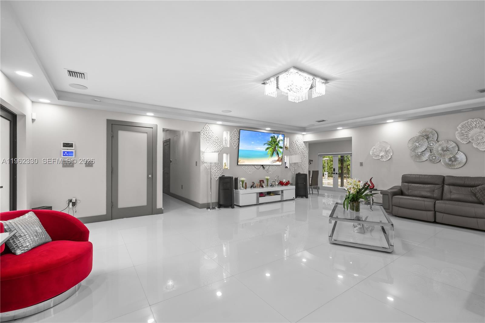 33300 Southwest 212th Avenue Homestead, FL 33034 - Photo 13 of 60 a living room with furniture and a chandelier