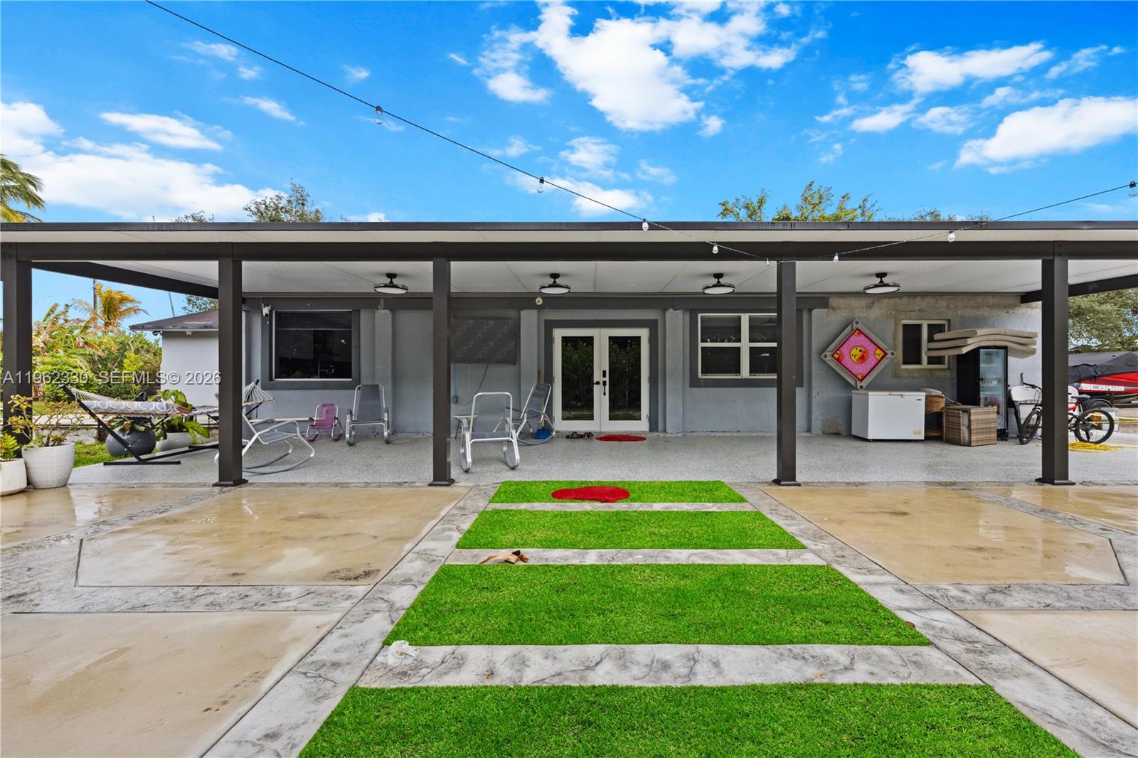 33300 Southwest 212th Avenue Homestead, FL 33034 - Photo 2 of 60 a view of a swimming pool with an outdoor seating