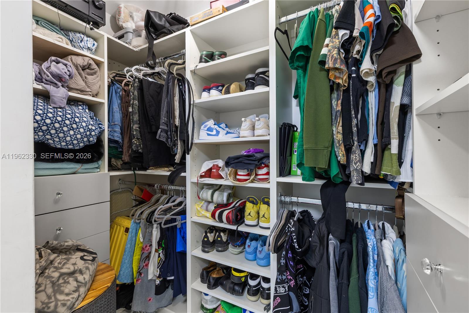 33300 Southwest 212th Avenue Homestead, FL 33034 - Photo 22 of 60 a view of walk in closet with clothes and shoes