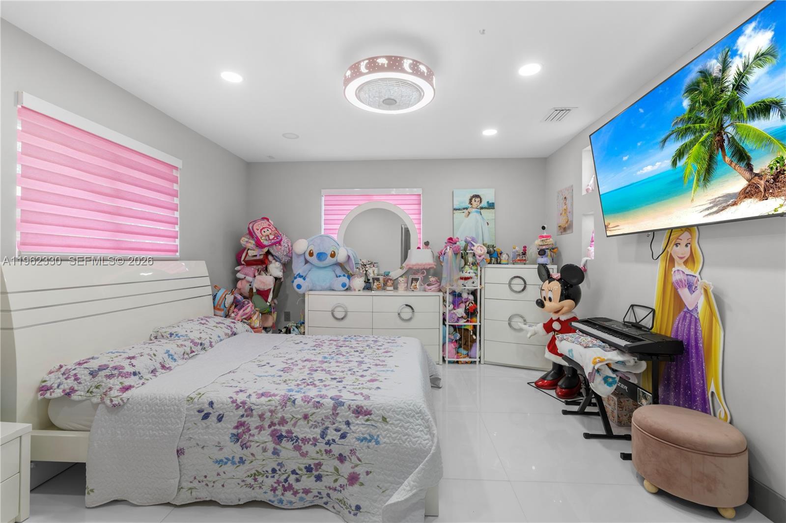 33300 Southwest 212th Avenue Homestead, FL 33034 - Photo 24 of 60 a bedroom with a bed and a chandelier