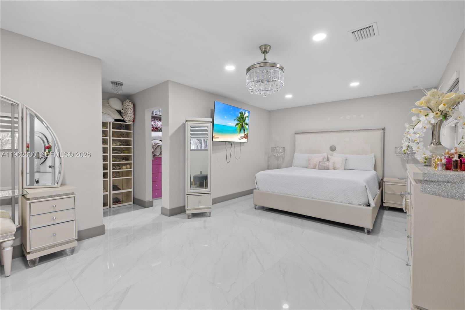 33300 Southwest 212th Avenue Homestead, FL 33034 - Photo 26 of 60 a spacious bedroom with a bed and a walk in closet