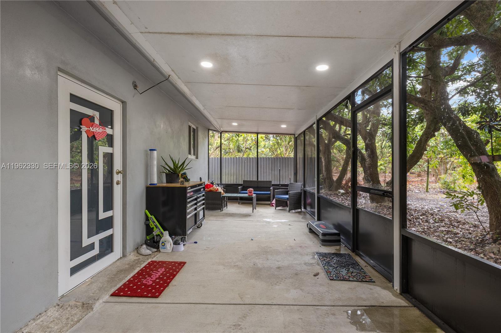 33300 Southwest 212th Avenue Homestead, FL 33034 - Photo 30 of 60 a living room with furniture and a large window