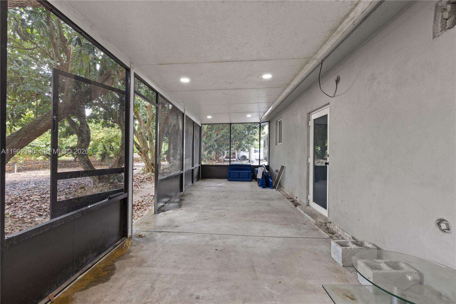 33300 Southwest 212th Avenue Homestead, FL 33034 - Photo 31 of 60 a large space with a large window and outdoor space