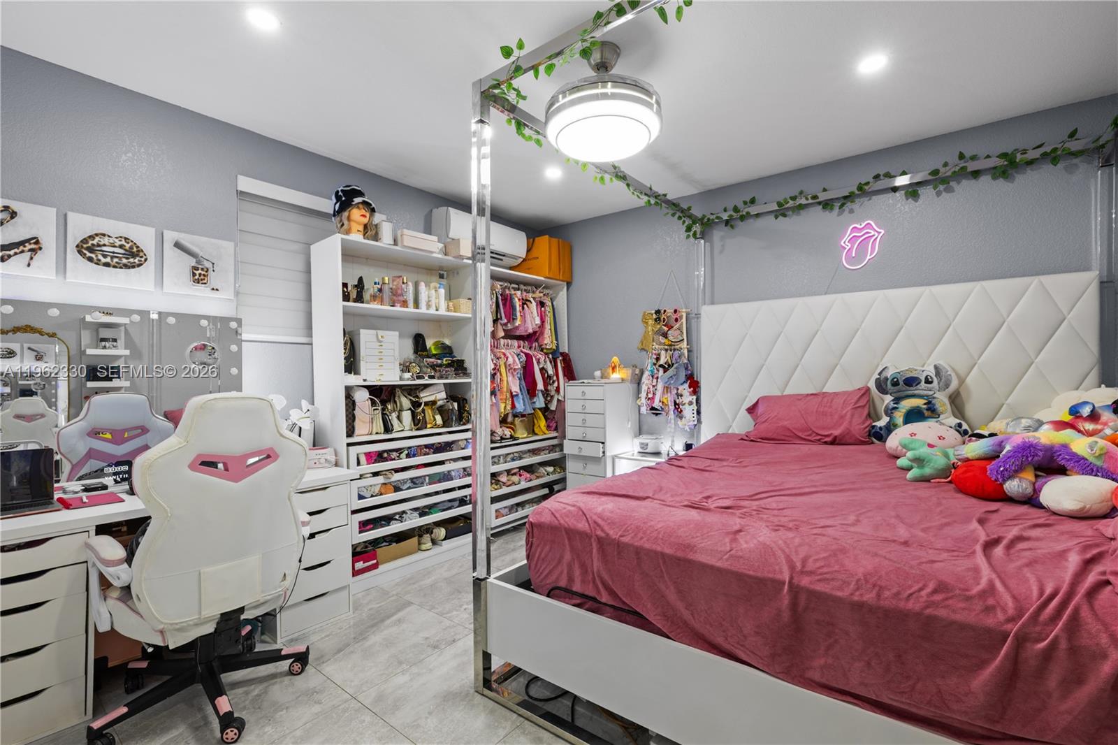 33300 Southwest 212th Avenue Homestead, FL 33034 - Photo 34 of 60 a bedroom with a bed and a chandelier