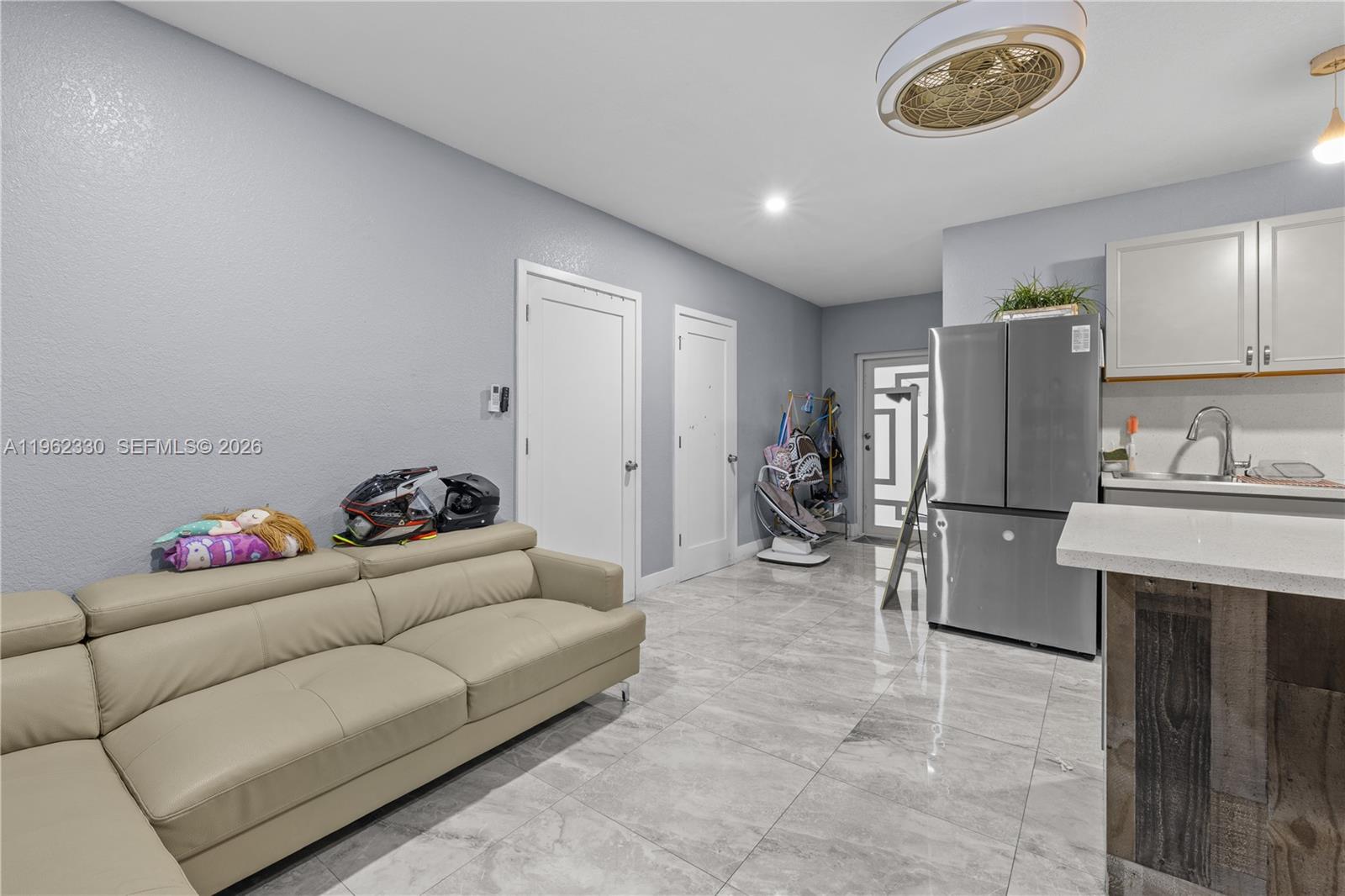 33300 Southwest 212th Avenue Homestead, FL 33034 - Photo 37 of 60 a living room with furniture and a refrigerator