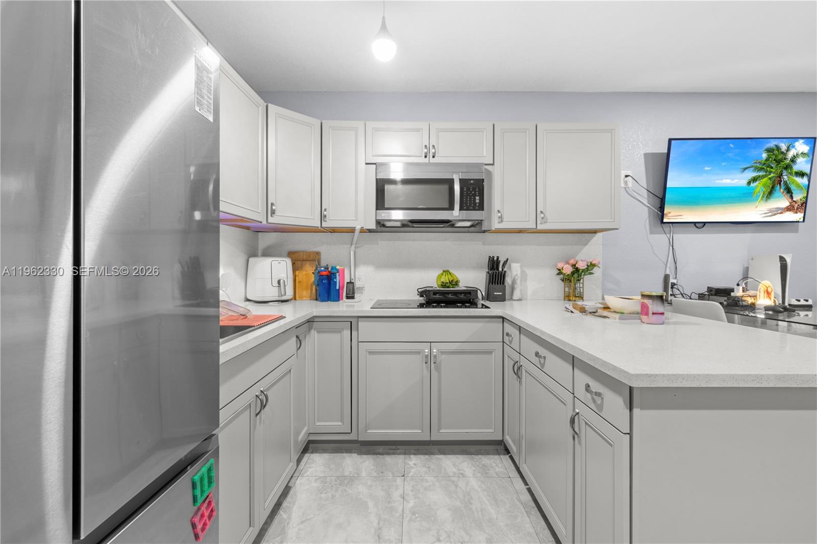 33300 Southwest 212th Avenue Homestead, FL 33034 - Photo 38 of 60 a kitchen with stainless steel appliances granite countertop a sink and a refrigerator