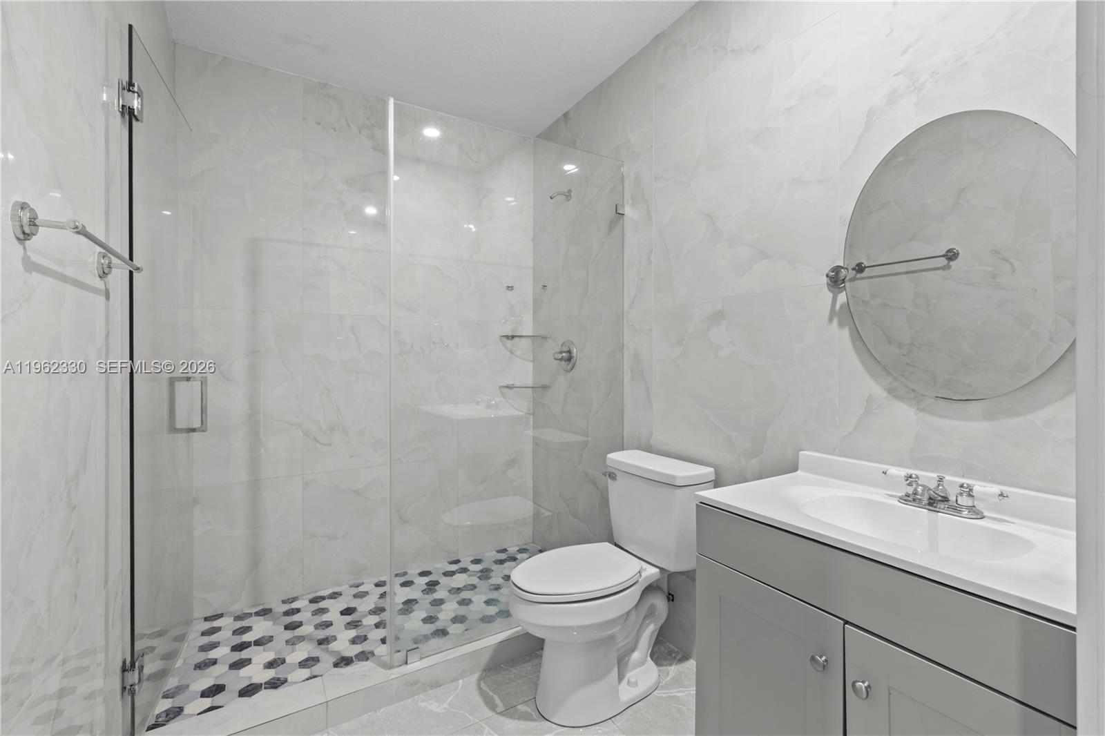 33300 Southwest 212th Avenue Homestead, FL 33034 - Photo 39 of 60 a bathroom with a granite countertop sink a toilet and shower