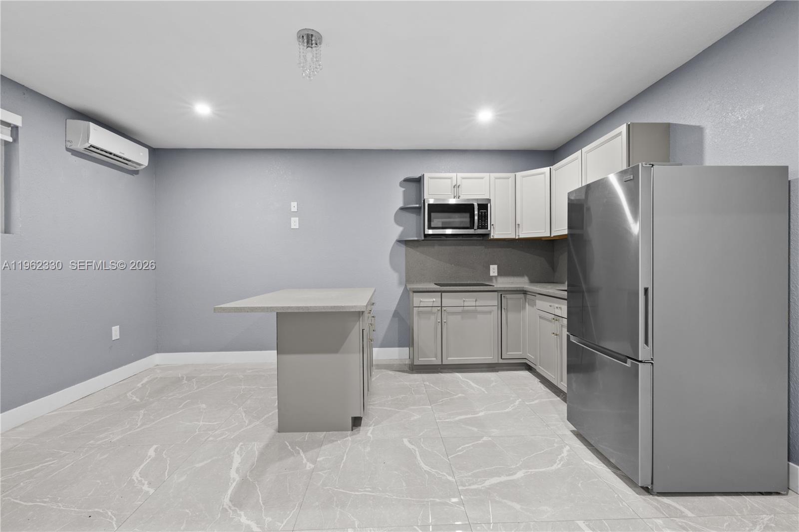 33300 Southwest 212th Avenue Homestead, FL 33034 - Photo 41 of 60 a kitchen with white cabinets and stainless steel appliances