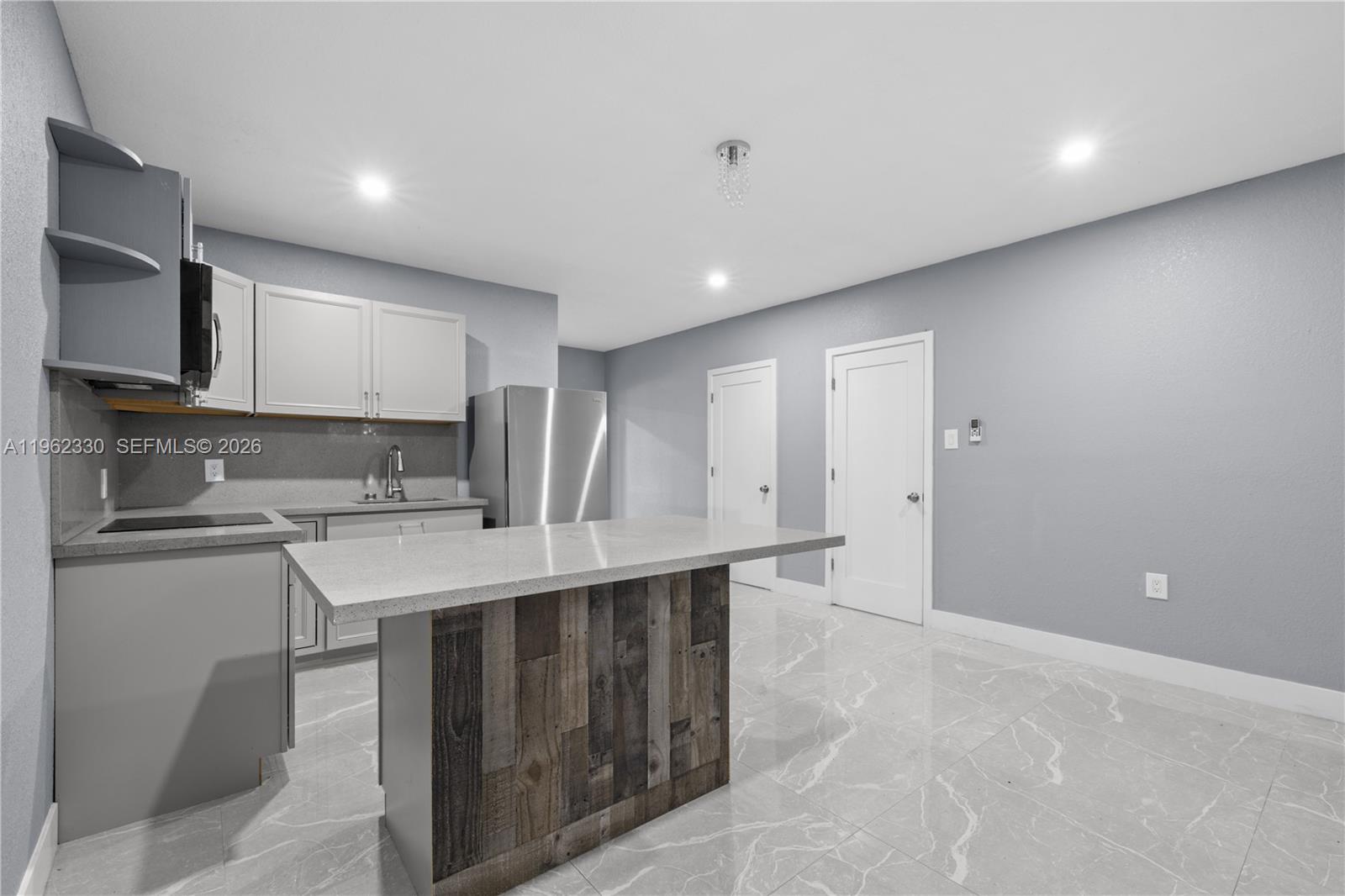 33300 Southwest 212th Avenue Homestead, FL 33034 - Photo 42 of 60 a kitchen with stainless steel appliances a sink stove and cabinets