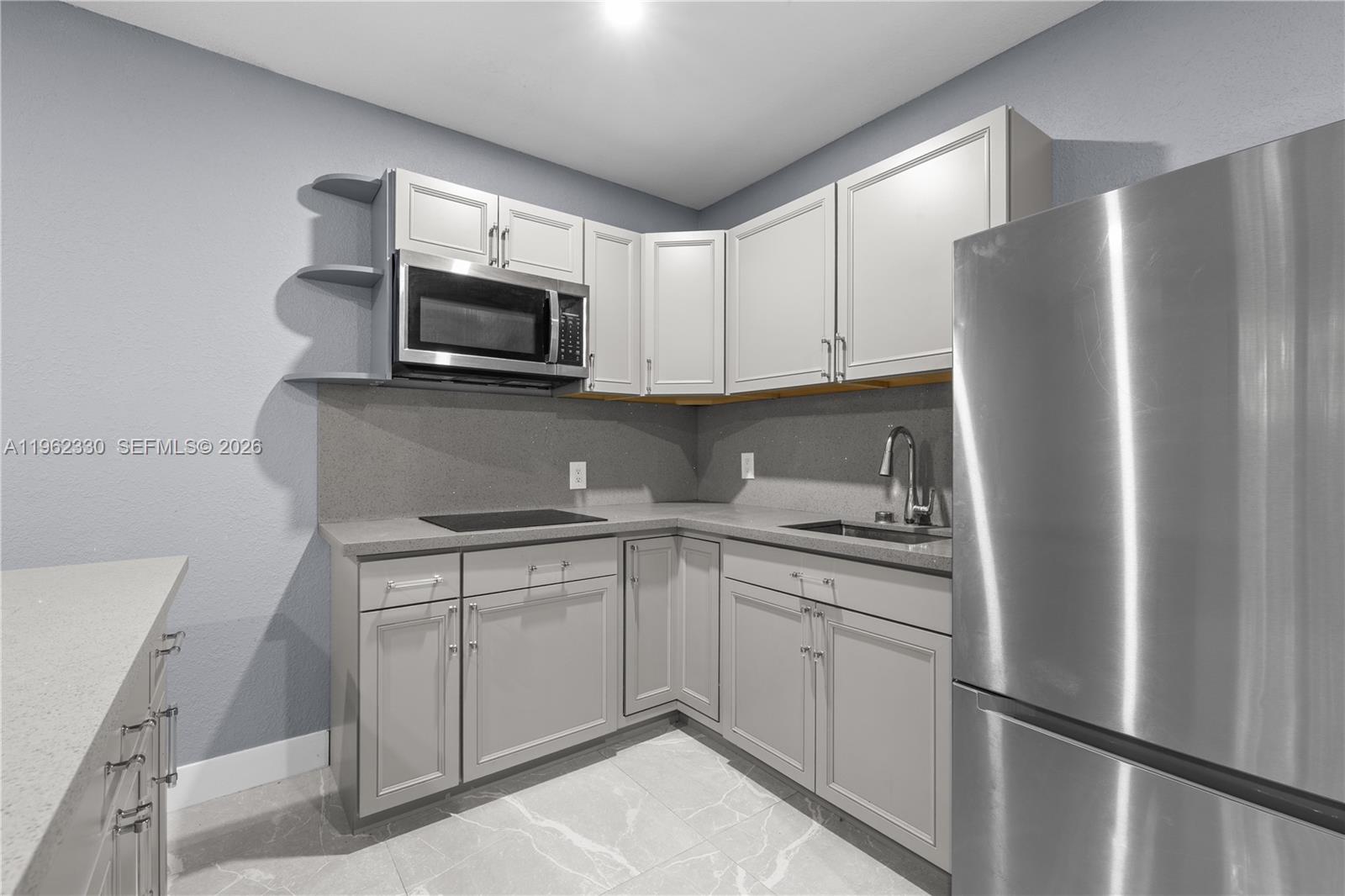 33300 Southwest 212th Avenue Homestead, FL 33034 - Photo 46 of 60 a kitchen with stainless steel appliances granite countertop a refrigerator sink and microwave