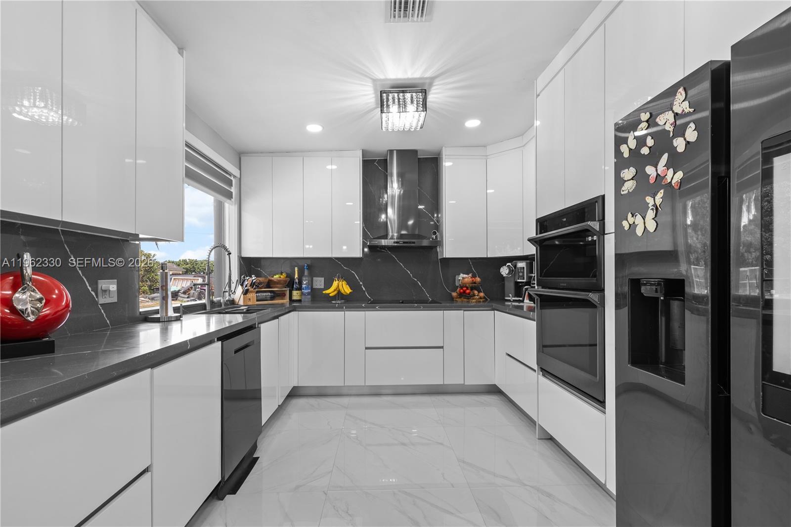 33300 Southwest 212th Avenue Homestead, FL 33034 - Photo 8 of 60 a kitchen with stainless steel appliances granite countertop a refrigerator a sink dishwasher a stove and white cabinets