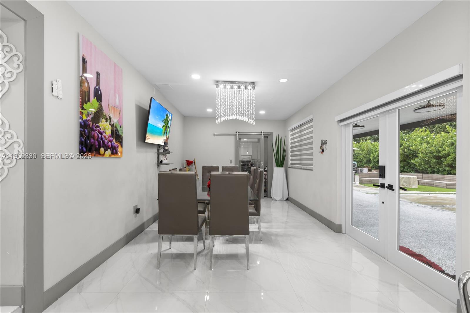 33300 Southwest 212th Avenue Homestead, FL 33034 - Photo 9 of 60 a view of a dining room with furniture a livingroom and chandelier