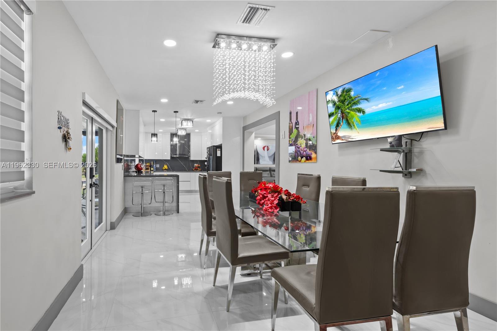 33300 Southwest 212th Avenue Homestead, FL 33034 - Photo 10 of 60 a view of a dining room with furniture and a chandelier