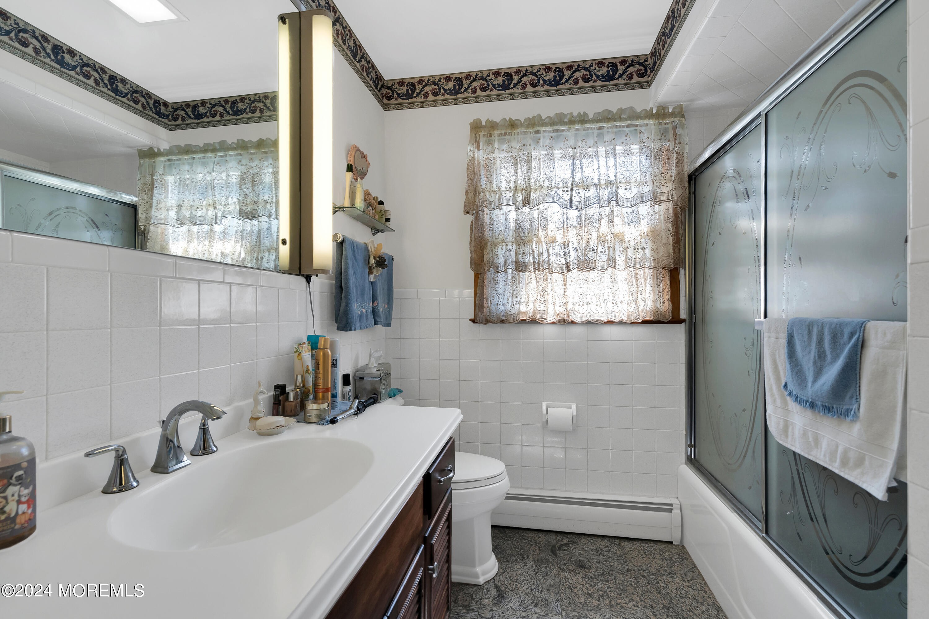 1521 Silverton Road Toms River, NJ 08755 - Photo 20 of 59 a bathroom with a sink a toilet and shower