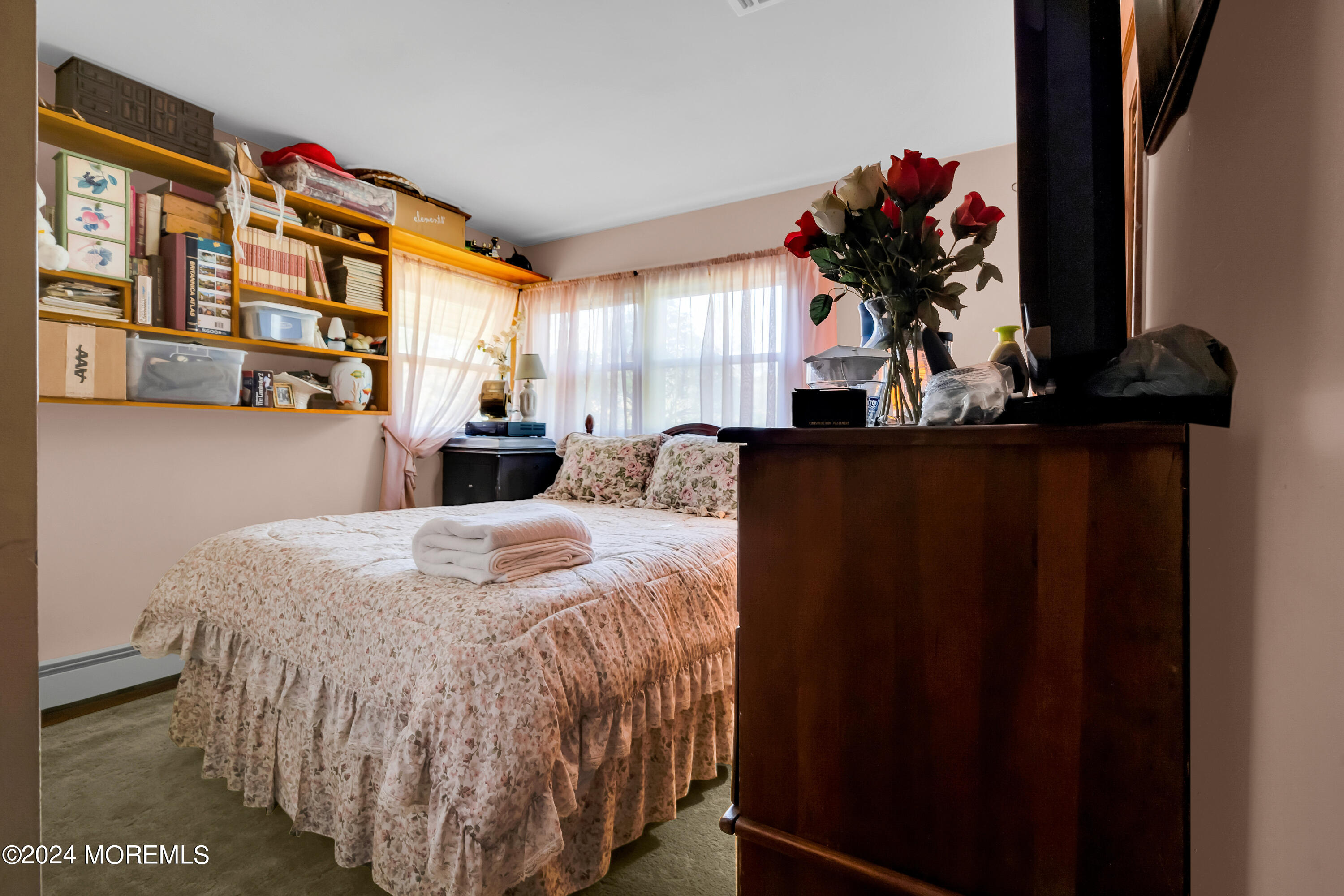 1521 Silverton Road Toms River, NJ 08755 - Photo 21 of 59 a bed sitting in a bedroom next to a window and a mirror