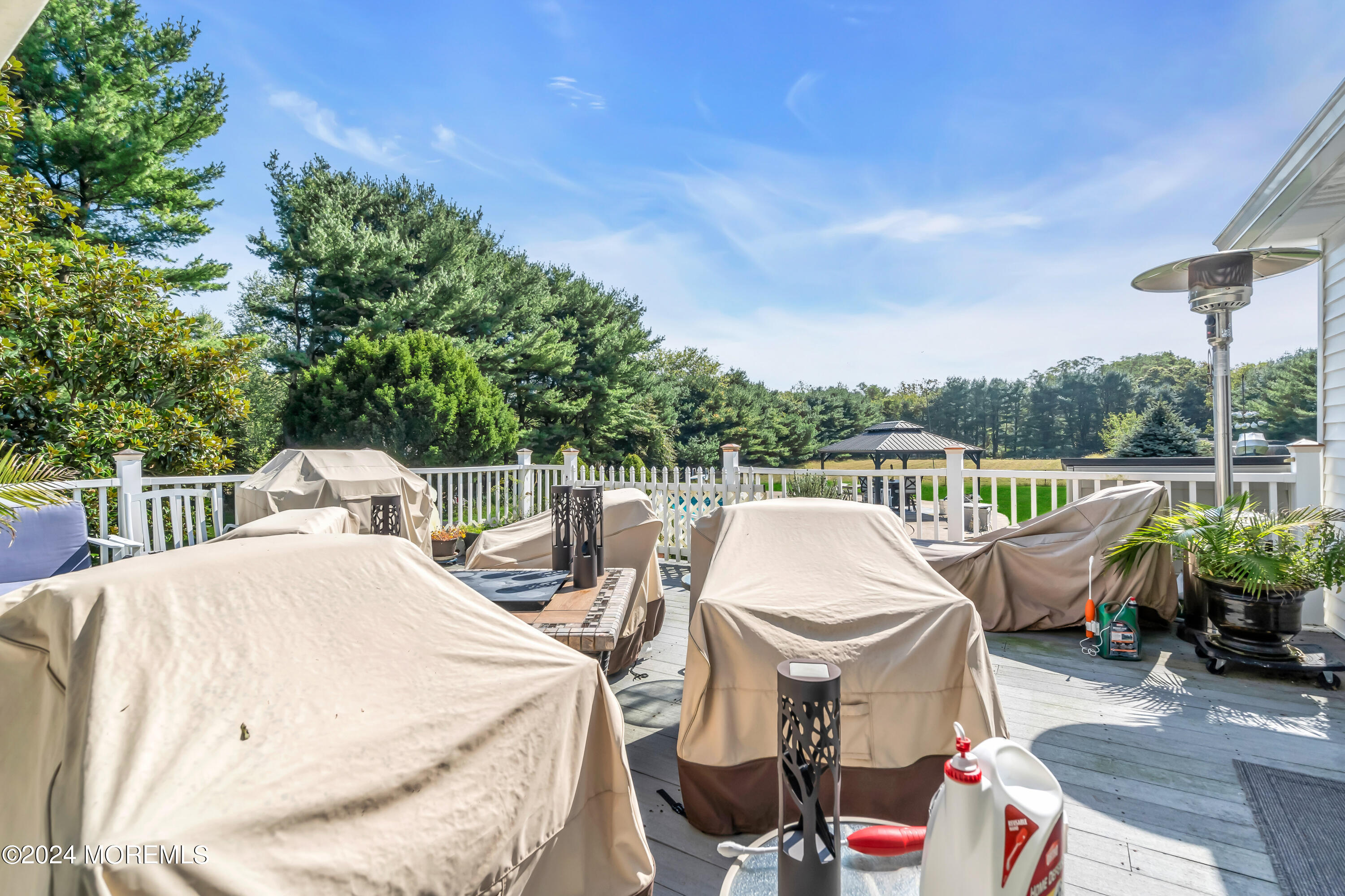 1521 Silverton Road Toms River, NJ 08755 - Photo 26 of 59 a roof deck with table and chairs potted plants with palm trees