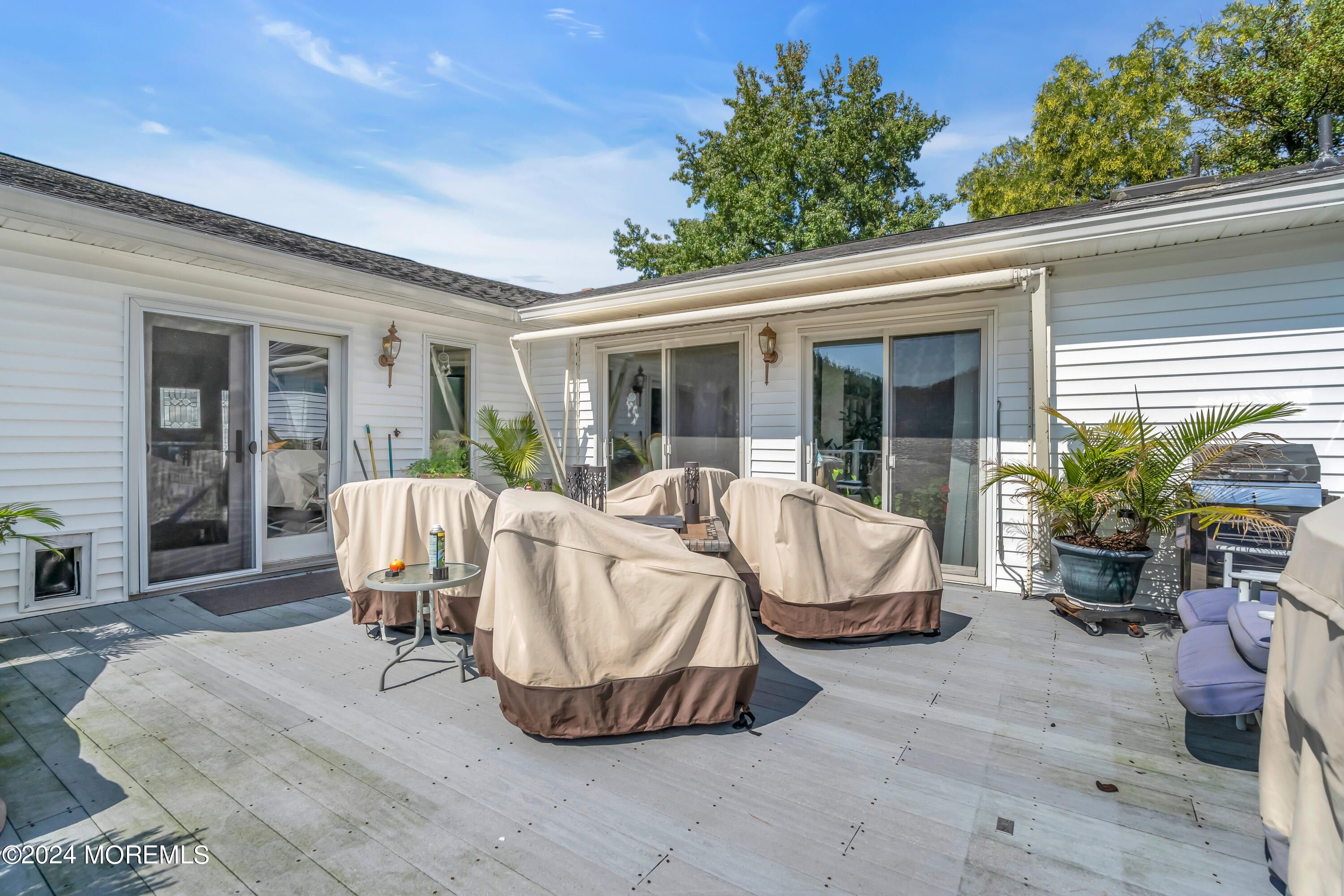1521 Silverton Road Toms River, NJ 08755 - Photo 27 of 59 a view of a patio with table and chairs potted plants and floor to ceiling window