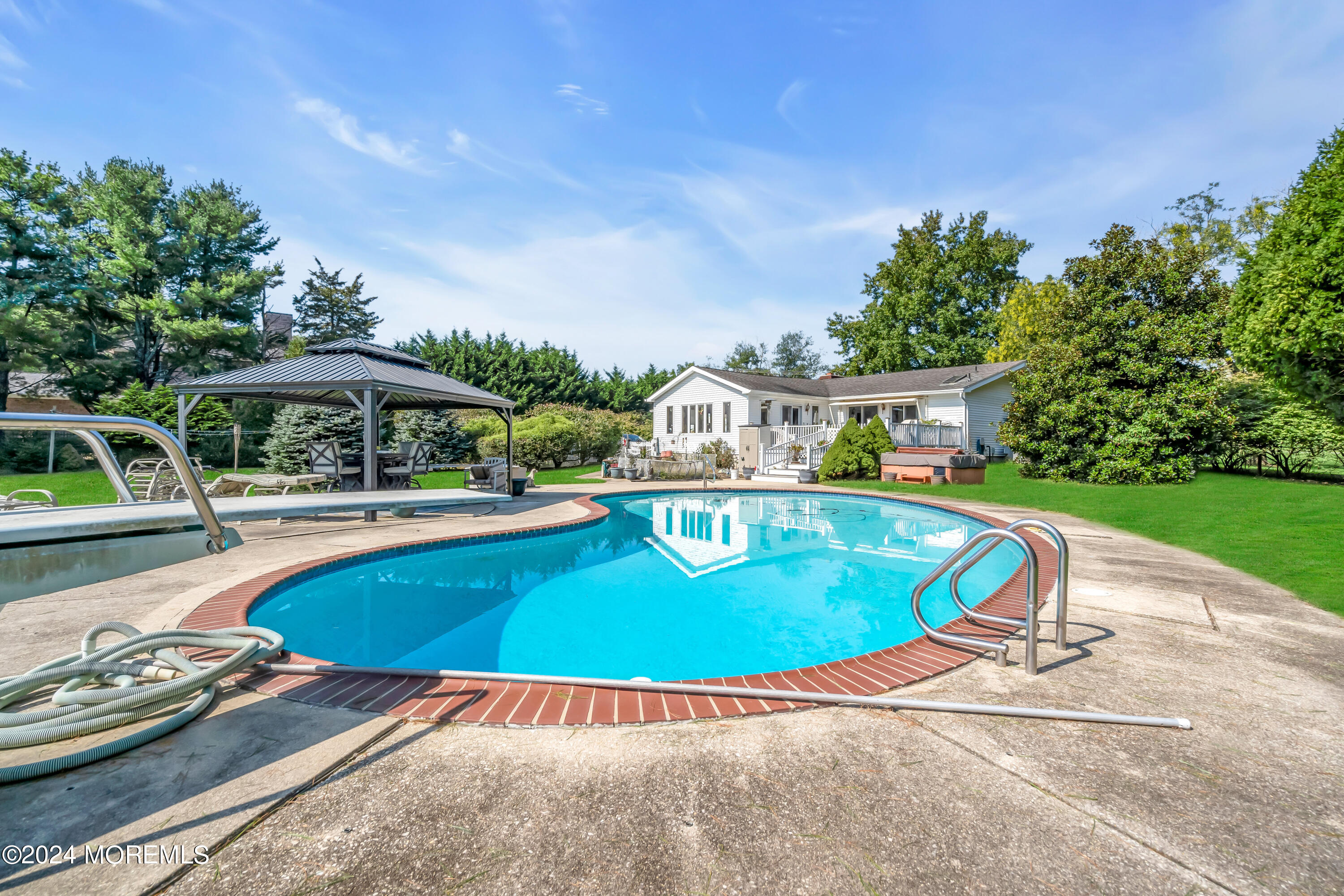 1521 Silverton Road Toms River, NJ 08755 - Photo 30 of 59 a view of a swimming pool with a garden