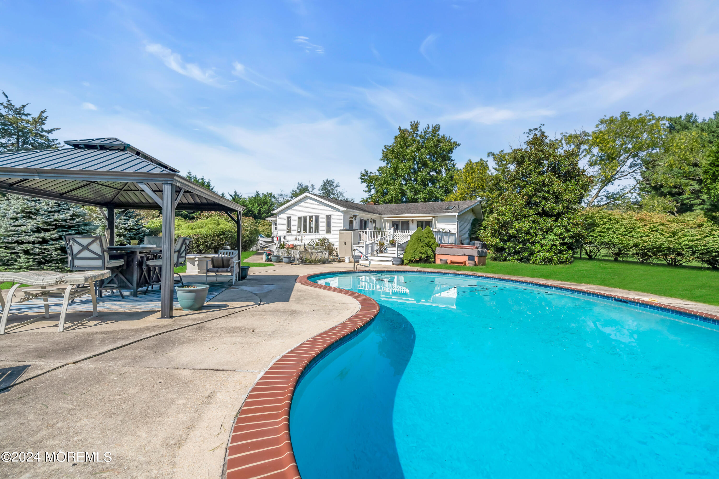 1521 Silverton Road Toms River, NJ 08755 - Photo 33 of 59 a view of swimming pool with lawn chairs under an umbrella