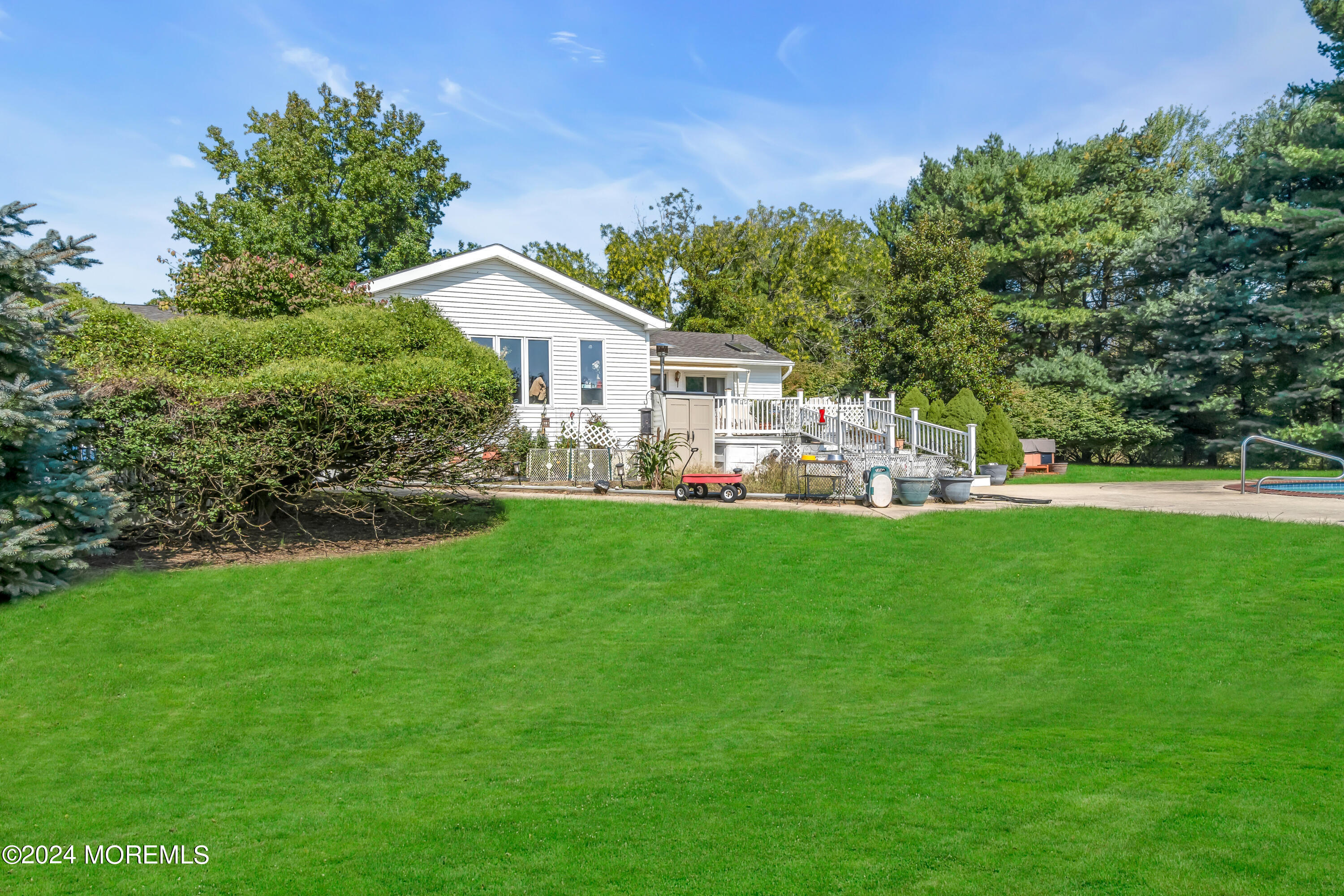 1521 Silverton Road Toms River, NJ 08755 - Photo 35 of 59 a front view of a house with a garden and trees