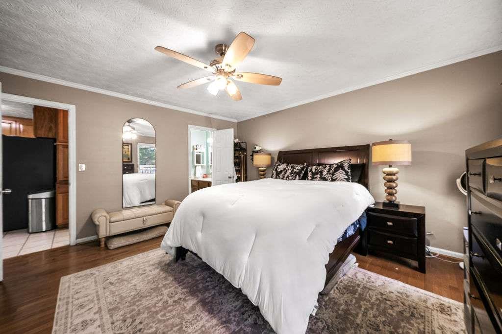 7 College View Drive Southwest Rome, GA 30161 - Photo 22 of 49 a bedroom with a bed and a chandelier