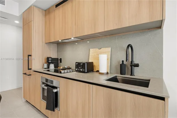a kitchen with stainless steel appliances granite countertop a sink and cabinets