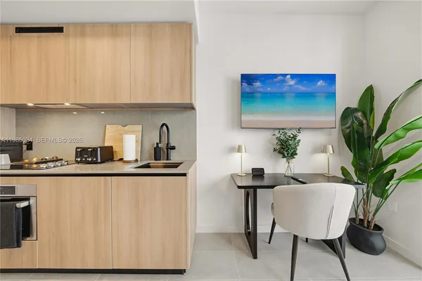 a kitchen with a table and chairs in it