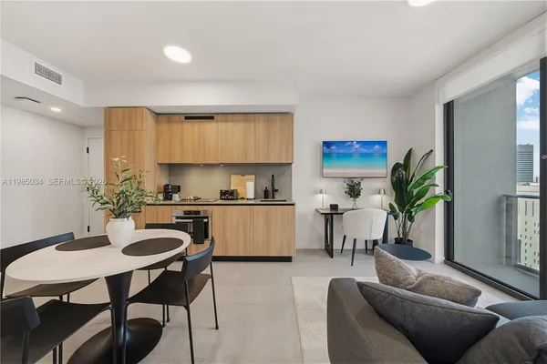 a living room with kitchen island furniture and a kitchen