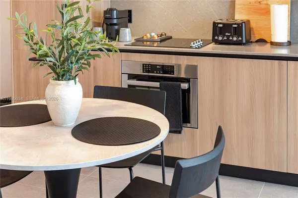 a table with chairs and a potted plant
