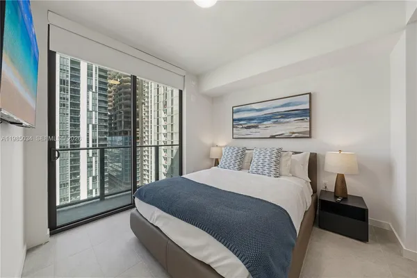 a bedroom with a large bed and a large window