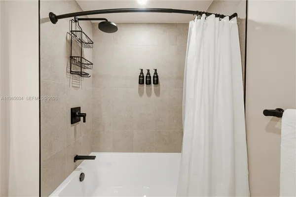 a bathroom with a shower and a tub