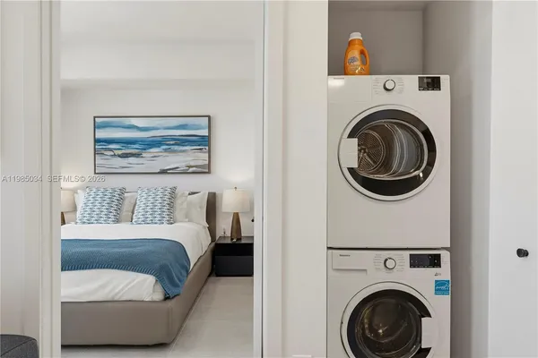 a bedroom with a washer and dryer