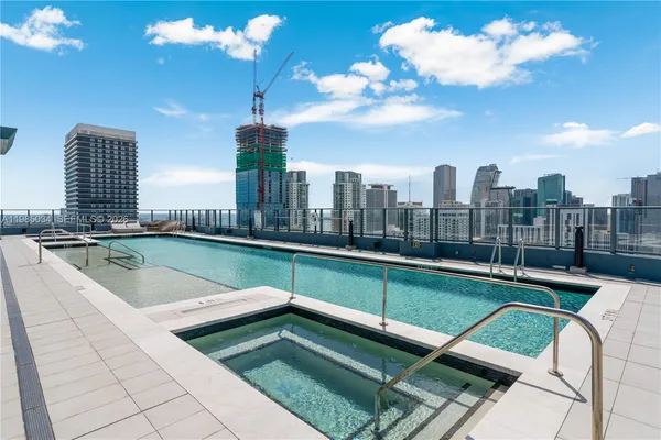 a view of swimming pool with chairs in patio