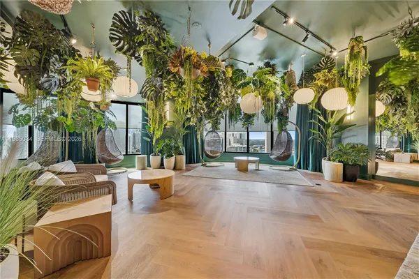 a view of a patio with couches and table and chairs with wooden fence