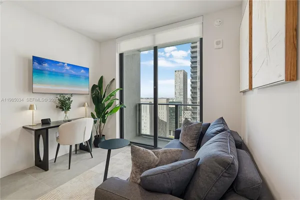 a living room with furniture and a potted plant