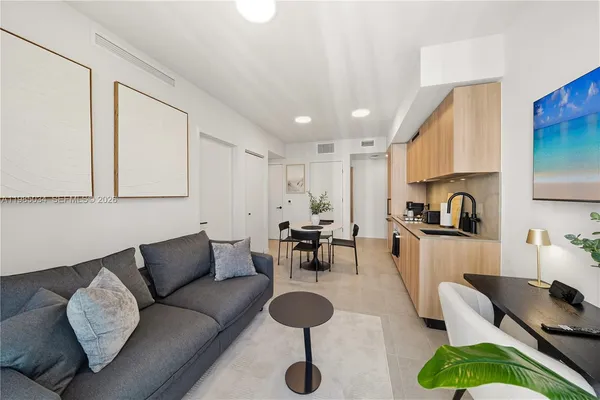 a living room with furniture and a hard wood floor