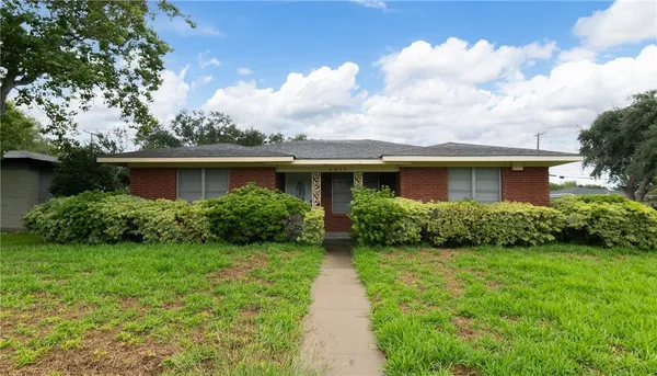 a view of an house with backyard space and garden