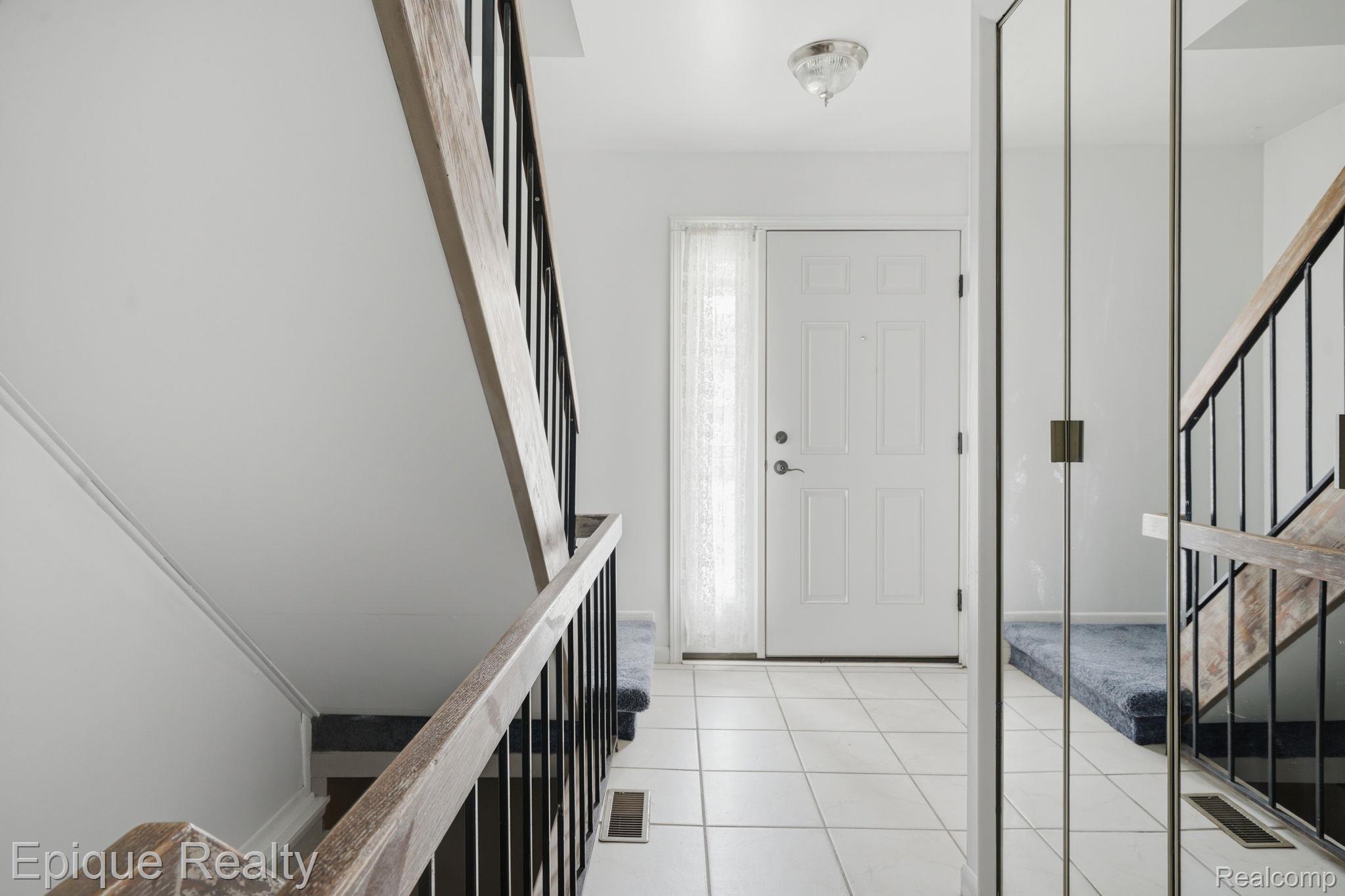 3895 Old Creek Road Troy, MI 48084 - Photo 10 of 23 Foyer with stairs and light tile patterned floors