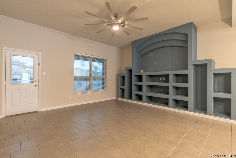10230 Midsummer Meadow Converse, TX 78109 - Photo 12 of 37 a view of an empty room with a window and a kitchen