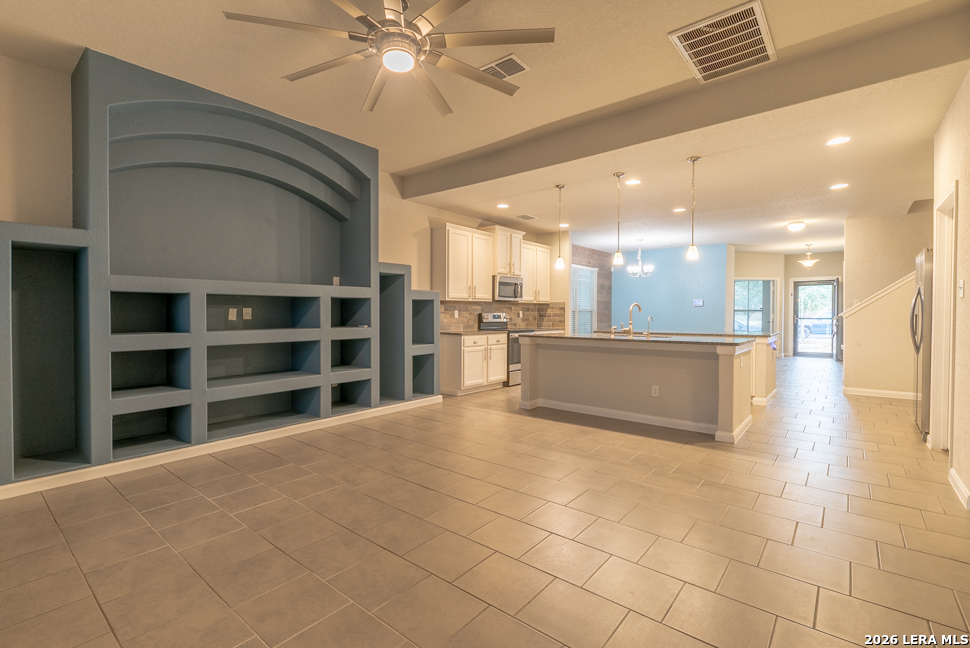 10230 Midsummer Meadow Converse, TX 78109 - Photo 13 of 37 a view of a kitchen with a sink and a kitchen island
