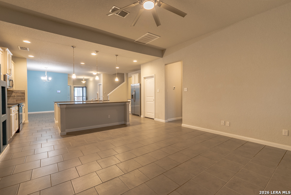 10230 Midsummer Meadow Converse, TX 78109 - Photo 14 of 37 a view of a kitchen with a sink and a refrigerator