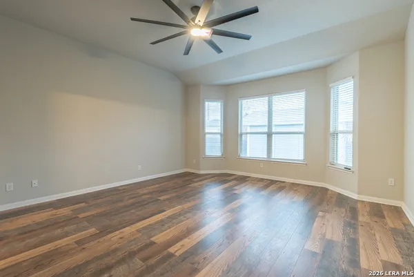 wooden floor in an empty room with a window