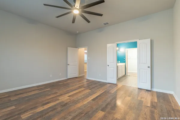 a view of an empty room and wooden floor