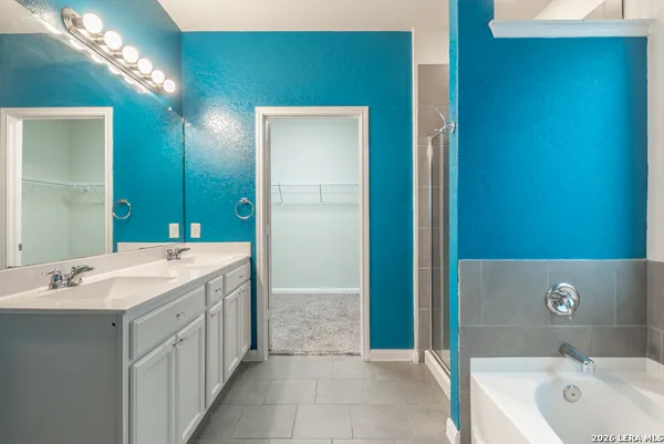 a spacious bathroom with a bathtub and a sink