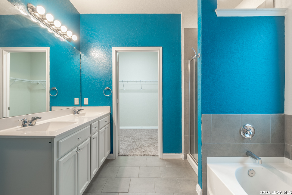 10230 Midsummer Meadow Converse, TX 78109 - Photo 18 of 37 a spacious bathroom with a bathtub and a sink