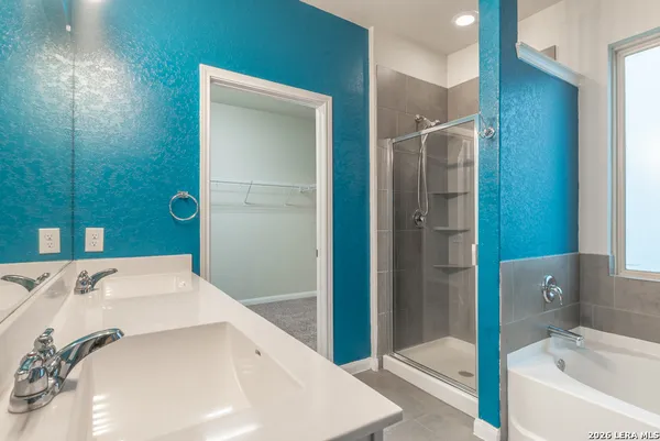 a bathroom with a tub and a sink